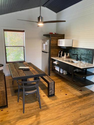 a kitchen with a table and a sink and a refrigerator at Hideout on the Horseshoe in Canyon Lake