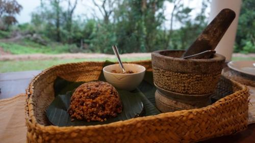 a basket with a plate of food on a table at Ella Nine Peaks in Ella