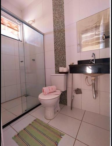 a bathroom with a toilet and a shower and a sink at Casa Amarela na Praia de Guaibim-Taquari in Guaibim