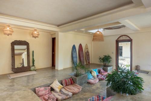 a living room with surfboards on the wall at Vedya Boutique Hostel in General Luna