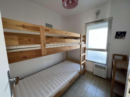 deux lits superposés dans une chambre avec fenêtre dans l'établissement 3P, Parking, Calme, Lave-Linge, Lave-Vaisselle, Animaux admis - FR-1-702-35, au Cap d'Agde