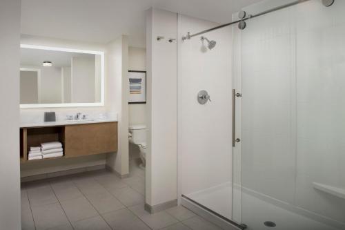 a bathroom with a shower and a sink at Staybridge Suites San Antonio Airport, an IHG Hotel in San Antonio