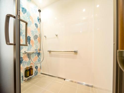 a shower with a glass door in a bathroom at Iseebisou in Ibusuki