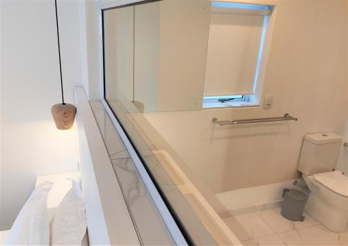 a bathroom with a shower and a toilet at Soli Deo Gloria, Pearl Studio in Paternoster