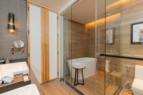 a bathroom with a shower and a sink and a toilet at Melia Chiang Mai in Chiang Mai