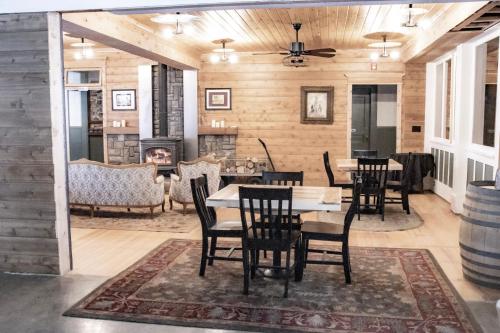 a dining room with a table and chairs and a fireplace at McCloud River Bed and Breakfast in McCloud
