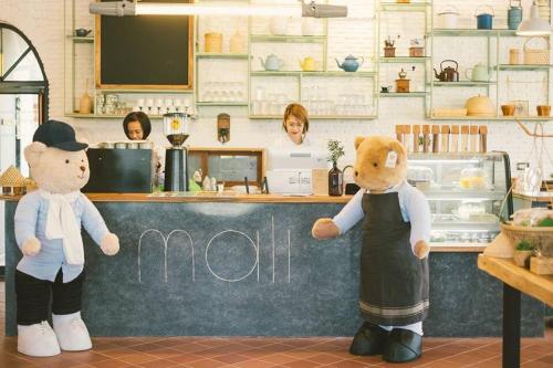 two teddy bears standing in front of a counter at Navela Hotel & Convention in Ratchaburi