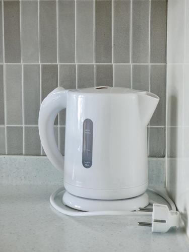 a white toaster sitting on top of a counter at Jeju the Ocean Hill Pension in Seogwipo