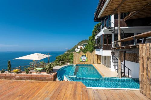 a swimming pool with a view of the ocean at Villa at Nai Harn Cape / Ocean Point in Nai Harn Beach