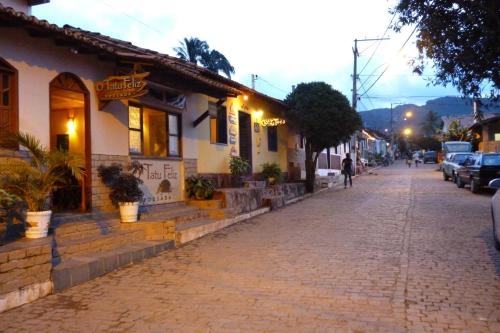 a cobblestone street in front of a building at Pousada Tatu Feliz in Vale do Capao