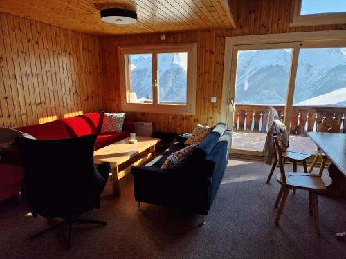 a living room with a couch and chairs and a table at Bettmeralp Chalet Zendorn in Bettmeralp