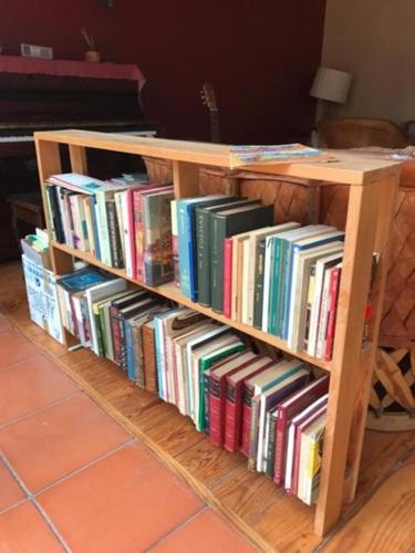 a book shelf filled with books in a room at Casa Campestre del Mangrullo in Mexico City