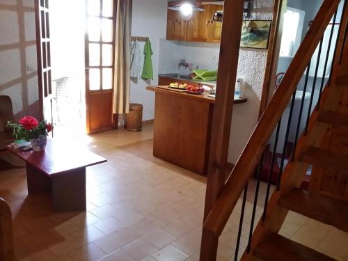 a kitchen with a staircase and a table in a room at Amazing Cottage close from the sea - Crete in Palaiochóra