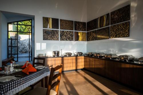 a kitchen with a table and a counter with pots and pans at Dvara Luxury Resort Kodaikanal in Kodaikānāl