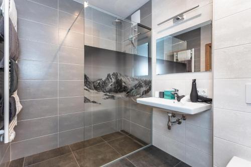 a bathroom with a sink and a shower at Lienbichl in Saalbach Hinterglemm