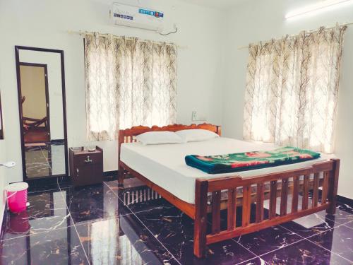 a bedroom with a bed and a mirror and curtains at MARARI CASA LINDA HOMESTAY in Mararikulam