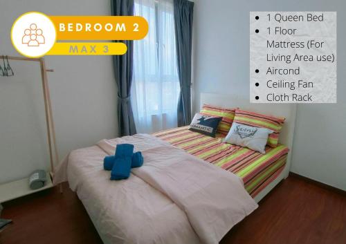 a bedroom with a bed with a blue cross on it at Cozy 2R2B Relaxing Skyline Views #GA2 in Shah Alam
