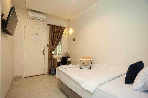 Ένα ή περισσότερα κρεβάτια σε δωμάτιο στο Urbanview Hotel Bong Gajah Lampung