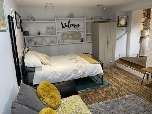 a bedroom with a bed and a couch in a room at The studio (Hideaway) Dog friendly in Matlock