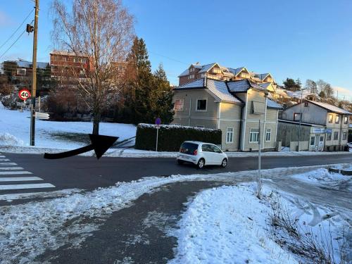 un coche aparcado en una calle en la nieve en Dammyr, close to City with parking, en Fredrikstad