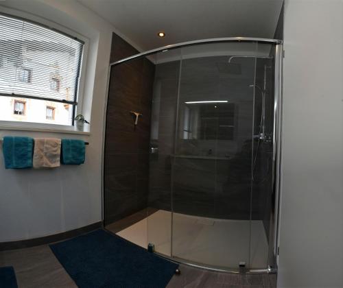 a shower with a glass door in a bathroom at Veranda Appartement Bergblick in Gries im Sellrain