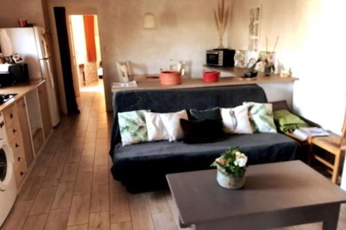 a living room with a couch and a table at Maison de village vue montagne in La Gaude
