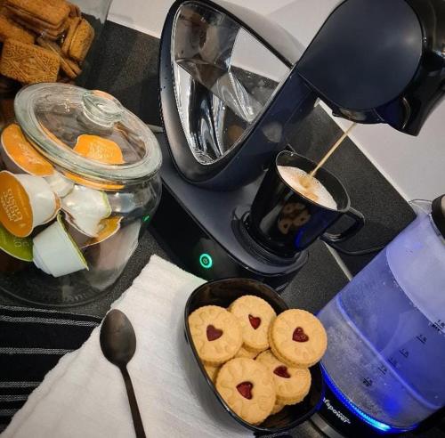 a counter top with a bowl of cookies and a mixer at Luxury 9ine SUPER BEAUTIFUL JACUZZI APARTMENT WITH BALCONY in Birmingham