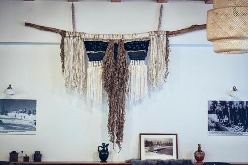 a room with a branch hanging from the wall at Pohorje Village Wellbeing Resort - Forest Apartments Videc in Pohorje