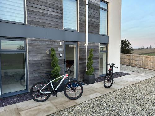 two bikes are parked outside of a house at The Retreat, Sauna & Hot Tub, Charming & Cosy Gem in Blandford Forum