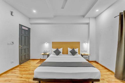 a bedroom with a large bed in a room at Upar Hotels Nungambakkam Nearby US Consulate Apollo hospital Sankara Nethralaya in Chennai