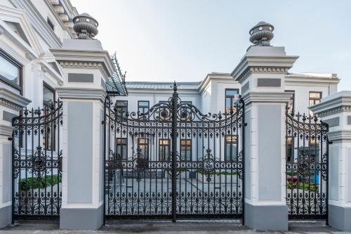 an ornate black gate in front of a white building at SIR LUXURY BOUTIQUE HOTEL in Brăila