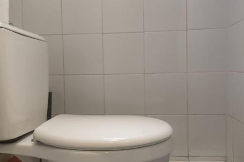 La salle de bains est pourvue de toilettes blanches. dans l'établissement Cosy Studio Paris Ternes Near Palais de Congrès, à Paris