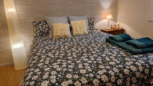 a bedroom with a large bed with pillows on it at ALOJAMIENTO MIRABUENOS in Aranda de Duero