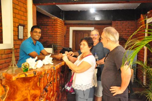 a group of people standing around a table at Sigiri Heritage Villa in Sigiriya