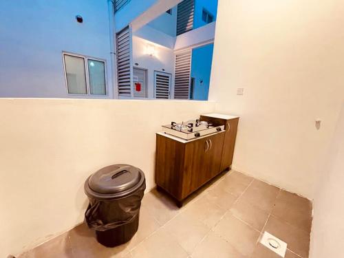 a bathroom with a sink and a trash can at The Misty Penthouse in Tanah Rata