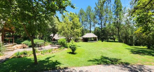 a large yard with a gazebo and trees at Pine Valley in Lanseria
