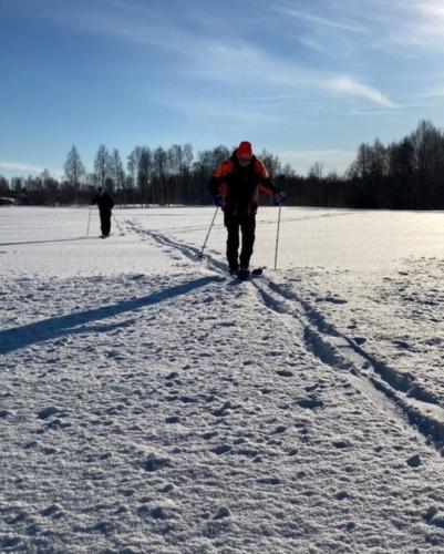two people are cross country skiing in the snow at Alanko Lodge in Tornio