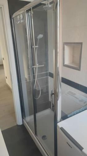 a shower with a glass door in a bathroom at Barzo Apartment in Rome