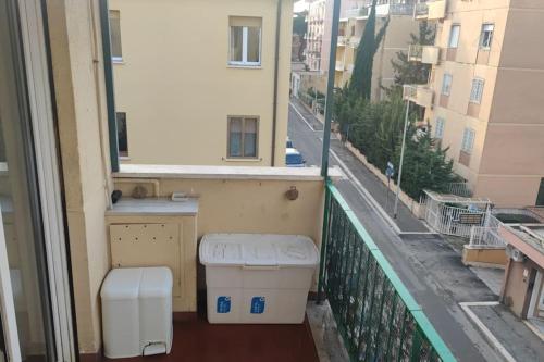 a balcony with a toilet and a view of a street at Barzo Apartment in Rome