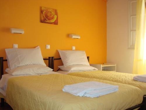 a bedroom with two beds with towels on them at Eleni's Apartments in Barbati