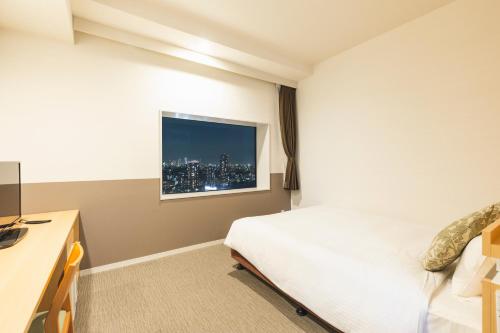 Ένα ή περισσότερα κρεβάτια σε δωμάτιο στο Hotel Crown Hills Ueno Premier