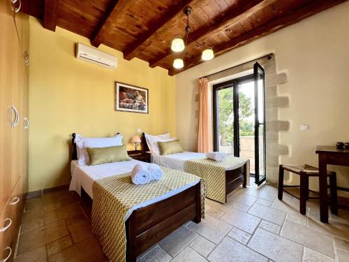 a bedroom with two beds in a room at Villa Afrati Sea Views Pool AC in Plaka