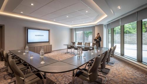 a woman standing in a room with a large conference table at Maldron Hotel Merrion Road in Dublin