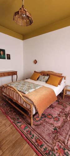 a bedroom with a large bed with a rug at Les Colibris - Standing et Jardin - 3 étoiles in Cluses
