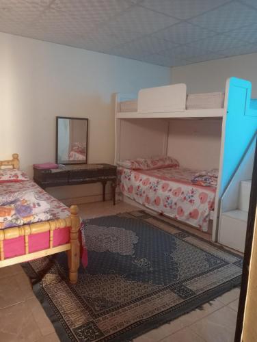 a bedroom with two bunk beds and a mirror at Sphinx Dream Nights Cairo in Cairo