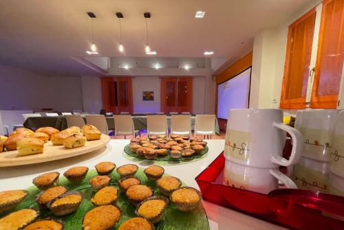 a table with some muffins and a coffee mug at MalaMù BnB Eventi in Rigosa