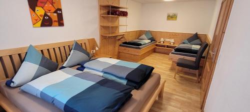a small bedroom with a bed and a desk at Auszeit 177 in Piesendorf