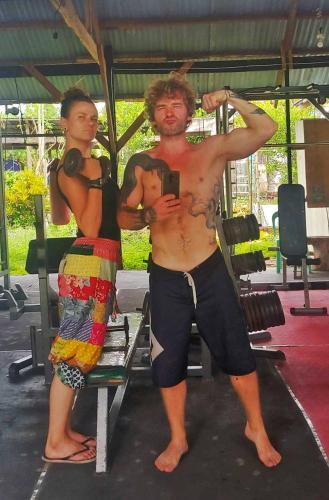 a man standing next to a woman in a gym at House of TamSe Laagans ' Inn in Badian