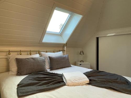 a bedroom with a large bed with a skylight at Stavanger Bnb nicolas 10 Terrace 2bed Rooms in Stavanger