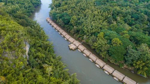 an overhead view of a long bridge over a river at River Kwai Jungle Rafts - SHA Extra Plus in Sai Yok